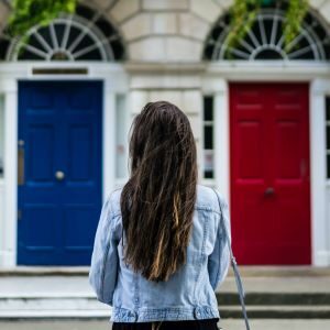 Like choosing a DASH diet or Mediterranean diet, a woman choosing between 2 doors